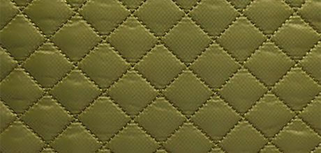 Olive green quilted fabric with a diamond pattern.